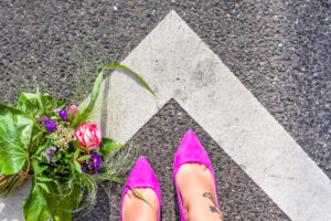 Bouquet on the street, feet, mauve women's shoes Bouquet on the street, feet, mauve women's shoes